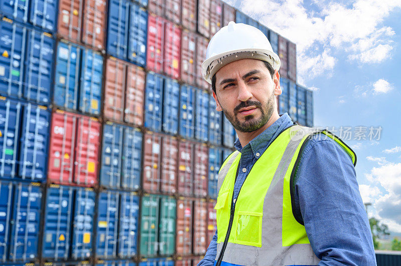 Portrait of Logistic worker engineer wears white helmets and safety vests working in cargo container warehouse industry factory site in export, import, and transportation concept.